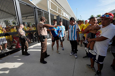 Policemen give instructions to fans